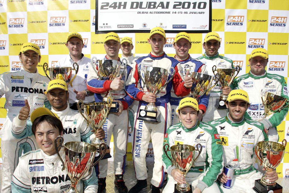 Porsche drivers on the podium at the Dubai 24 hour race