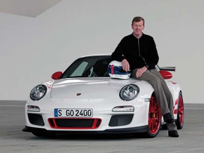 Porsche's Walter Rohl sitting on the hood of a 2010 911 GT3 RS