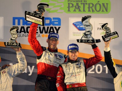 Porsche's Patrick Long and Joerg Bergmeister of the Flying Lizard Team accepting a trophy in Monterey at six hour ALMS event