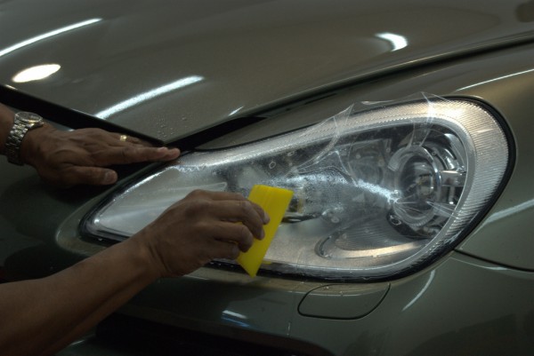 invisible bra material being installed on Porsche Cayenne headlight