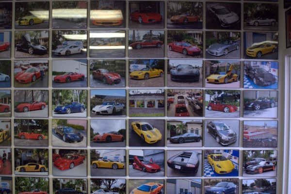 pictures of cars hanging on wall at Auto Super Shield