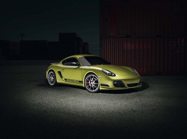 An olive green 2011 Porsche Cayman R as seen from the side