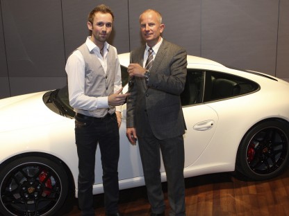 Porsche's Jens Walther present keys of a new Porsche to Rene Rast