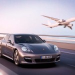 Porsche panamera Turbo S with jet flying next to it
