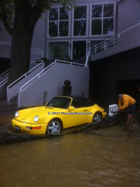 porsche being rolled onto uninflated bladder before river floods