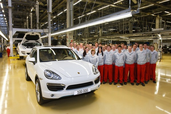 porsche factory works pose with 100000th Porsche cayenne