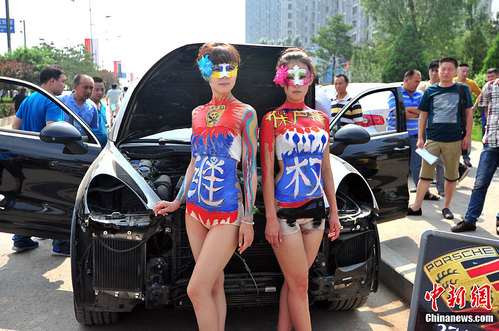 half naked chinese girls posing with Porsche Cayenne