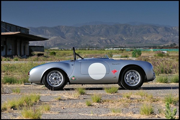 a Porsche 550 Spyder in weed covered field