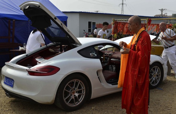 buddhist monks bless a Porsche Cayman