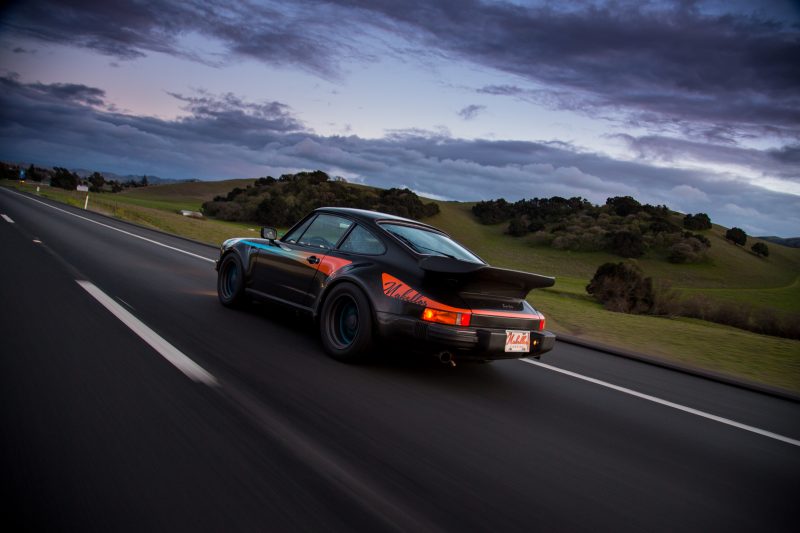 Dark skies cloud over 911 Turbo viewed from the rear
